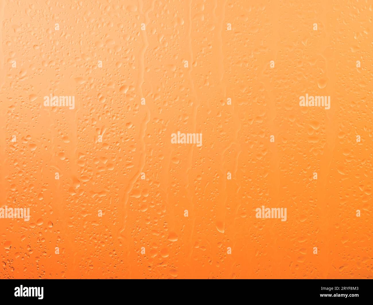 Raindrops on glass window over sunset sky Stock Photo