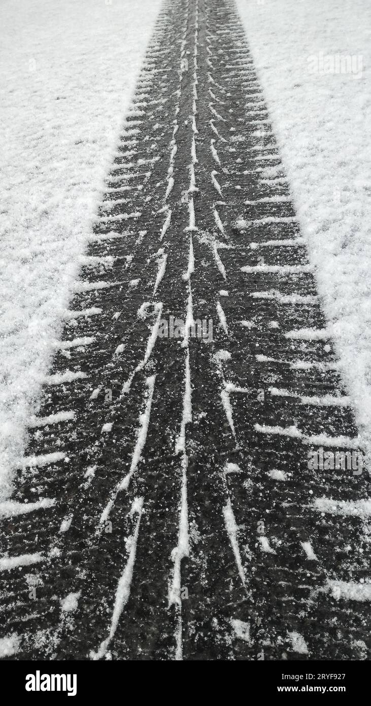 Tire tread footprint on white snow of winter road Stock Photo