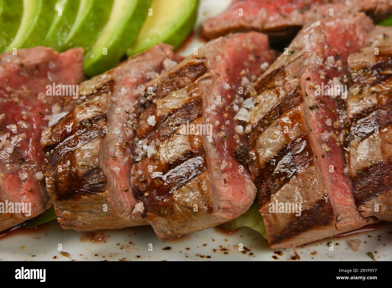 Grilled beef steak sliced to serve Stock Photo - Alamy