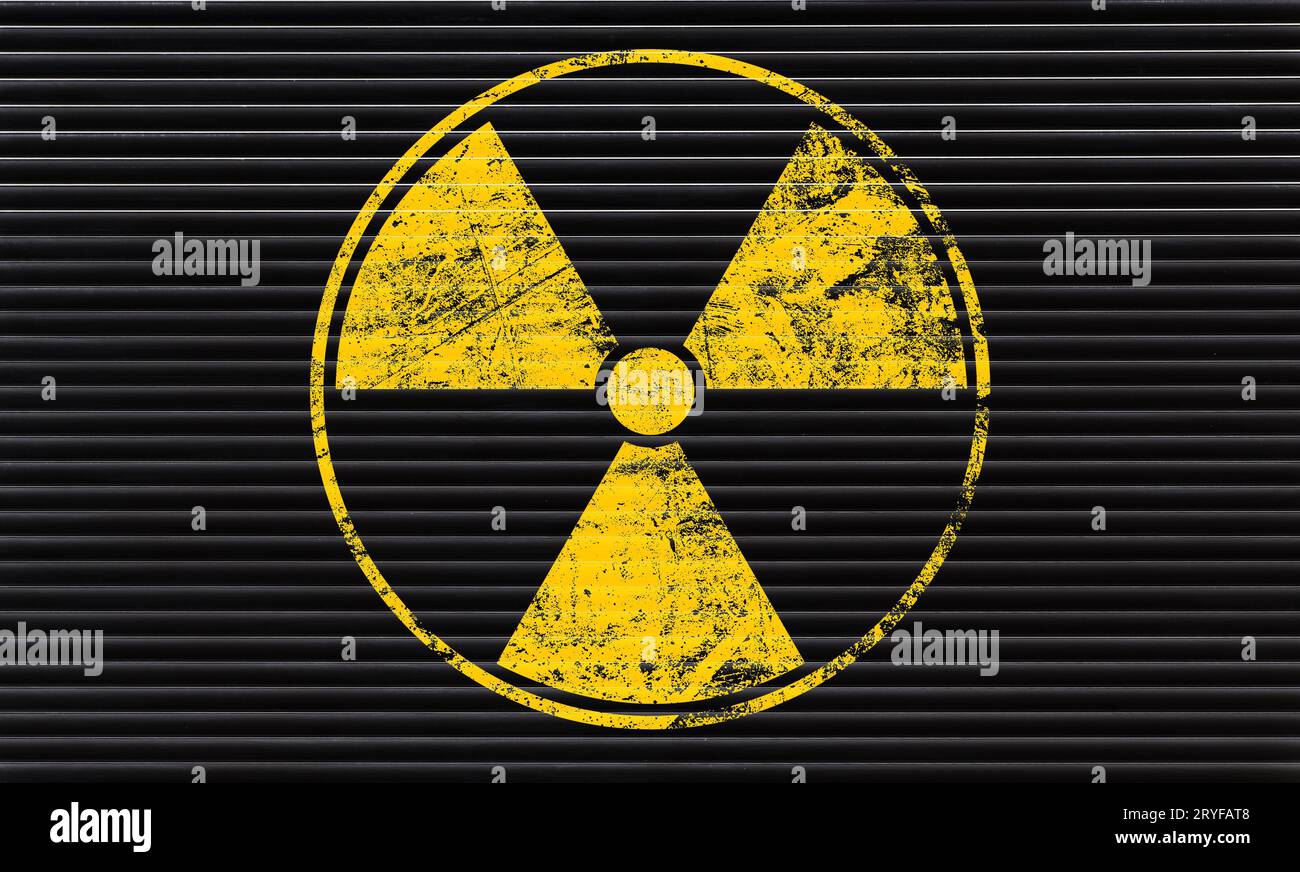 Yellow radioactive sign over black background Stock Photo