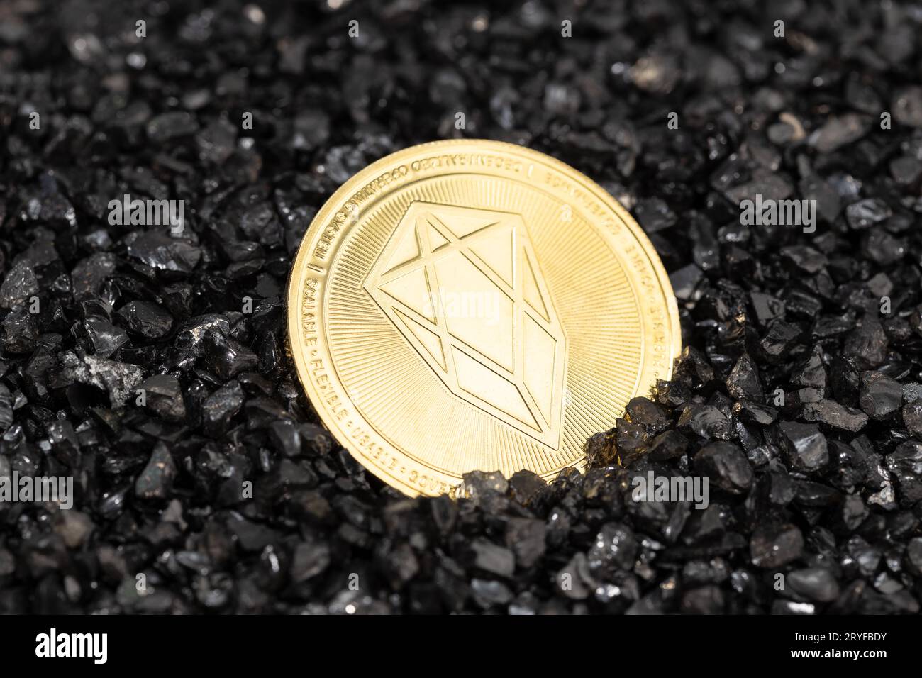 EOS coin on black gravel background. Cryptocurrency blockchain money Stock Photo