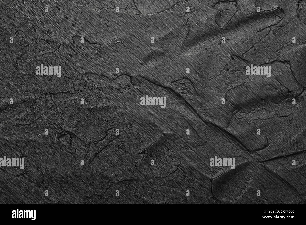 Black uneven grunge surface abstract background Stock Photo