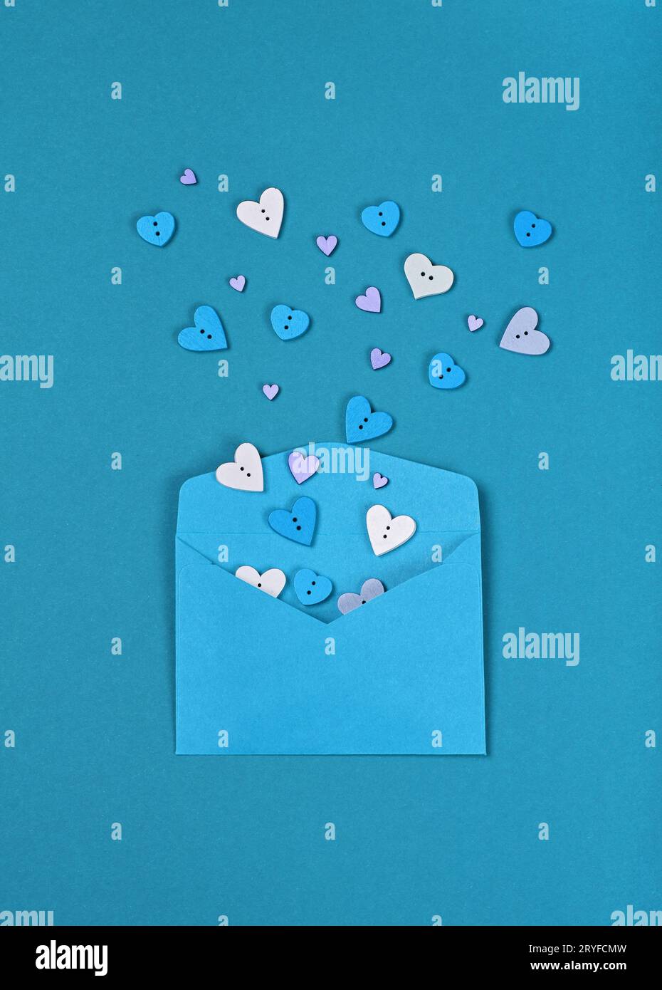 White hearts out of blue paper envelope Stock Photo