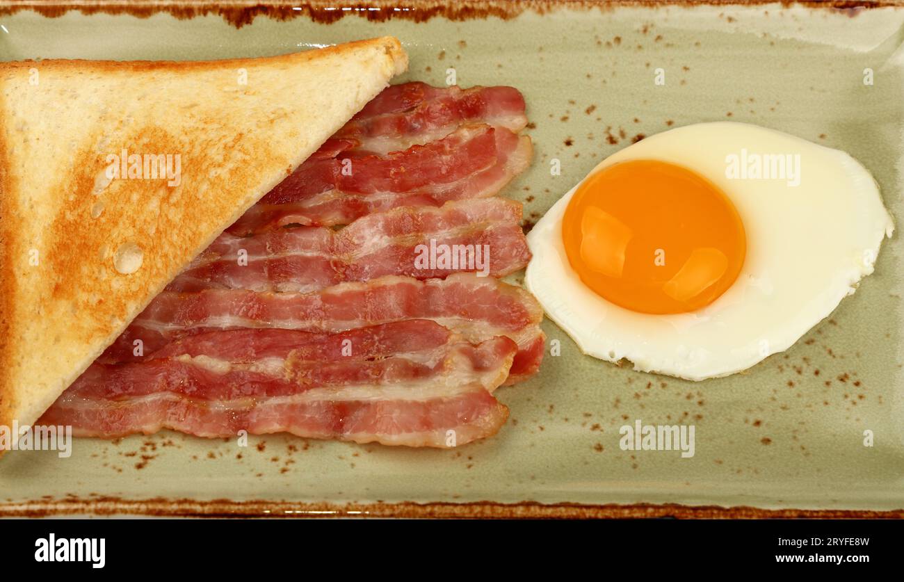 Close up egg, toast and bacon on plate Stock Photo