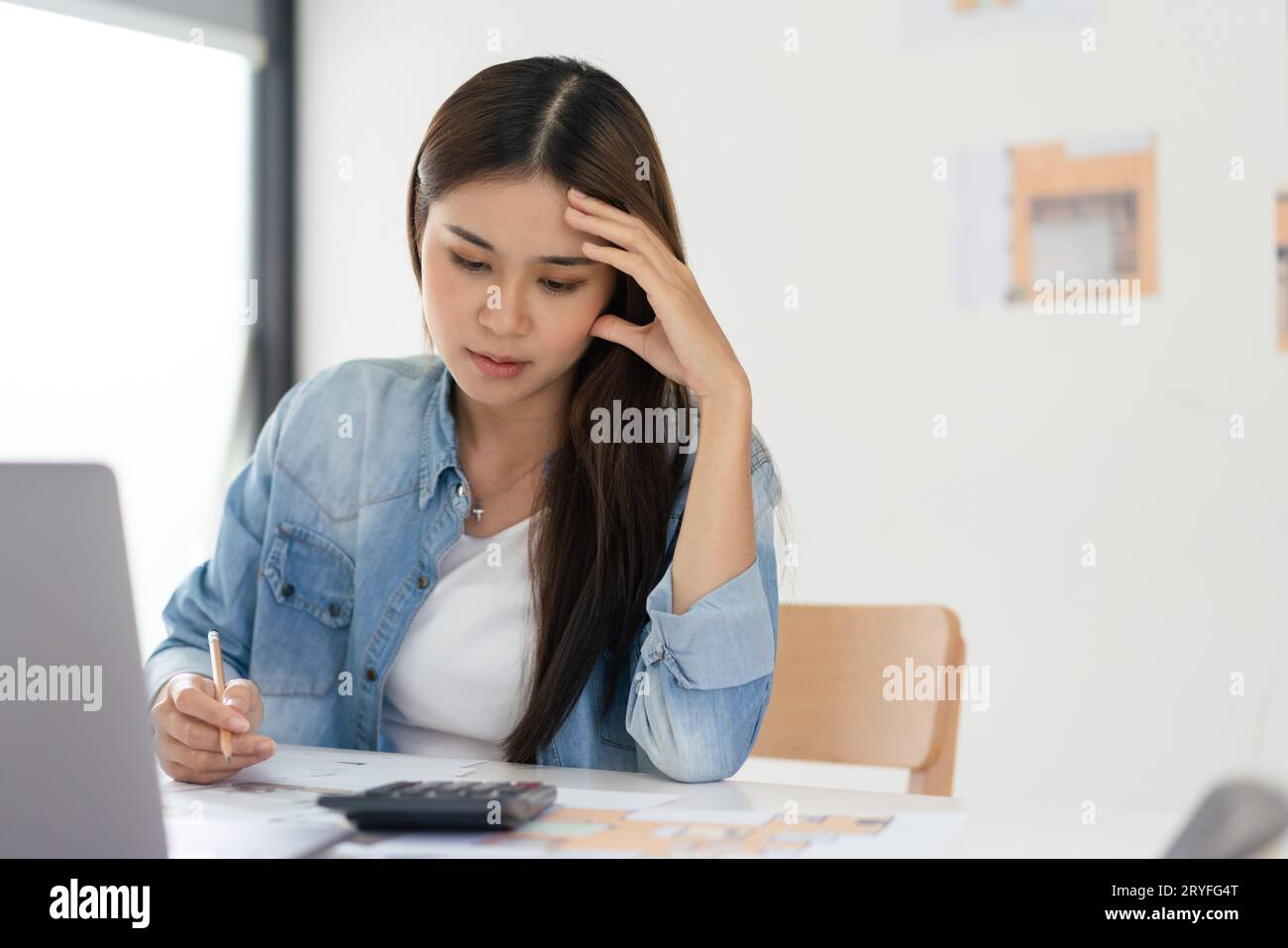 Construction business plan concept, Female architect feeling stressed while sketching house plan. Stock Photo