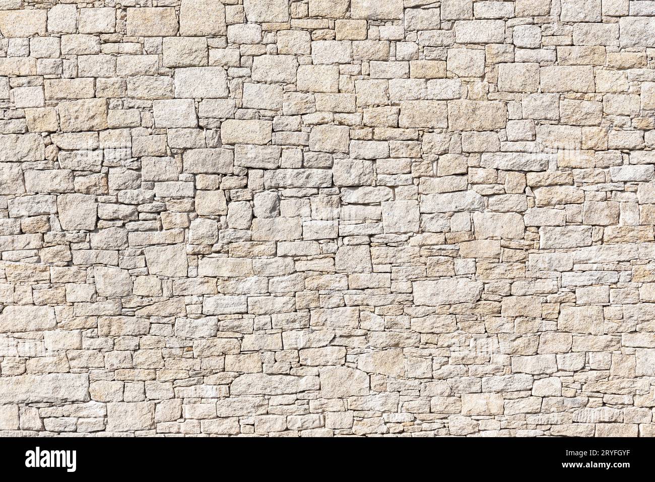 Granite Stone wall background texture. Dry masonry wall Stock Photo