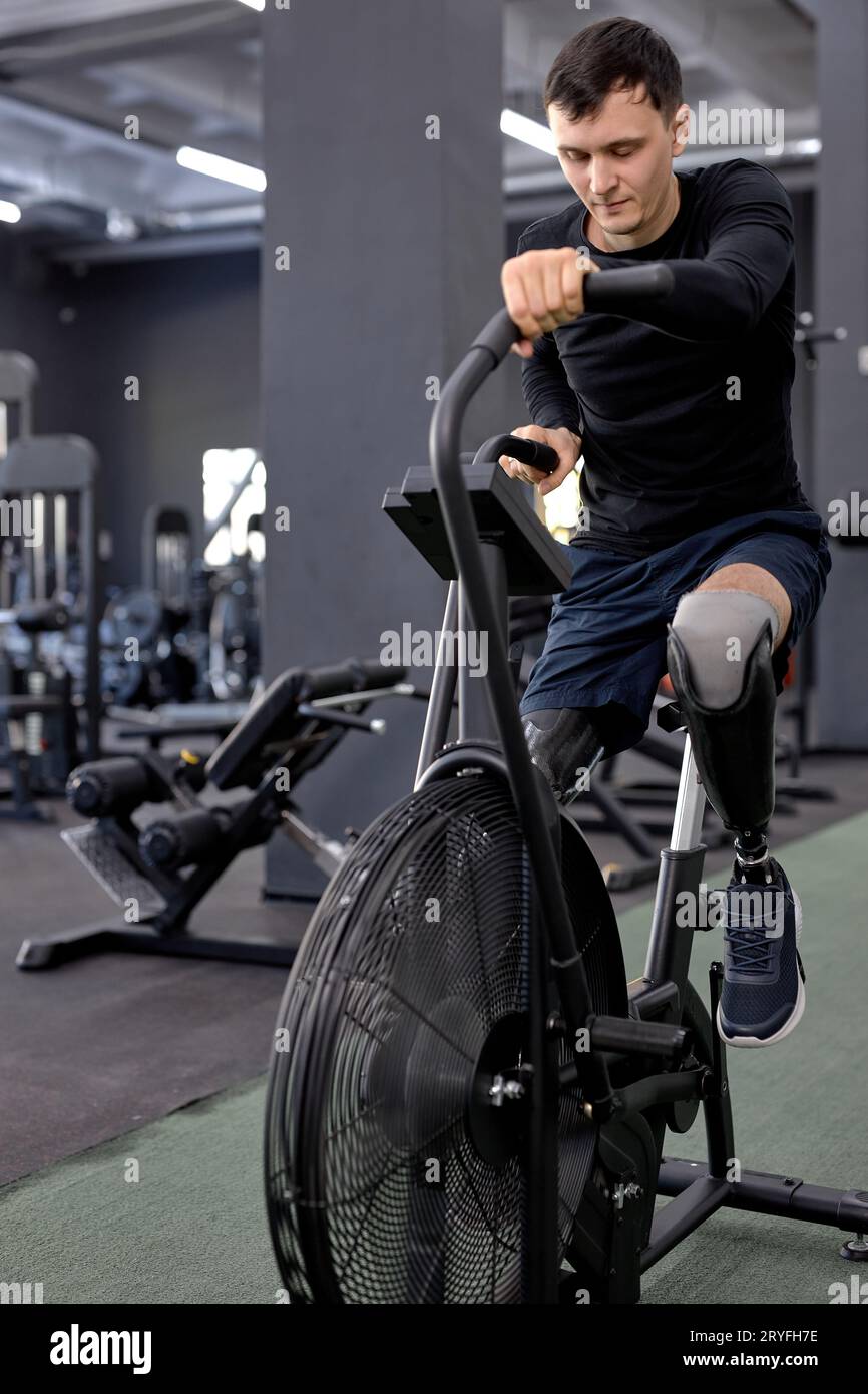 active man concentrated on working out on a stationary bike. A man is