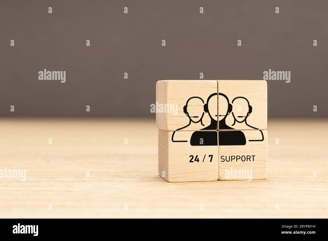 24-7 Customer support concept. Group of wooden block with Group of Call Center Workers icon. Copy space Stock Photo