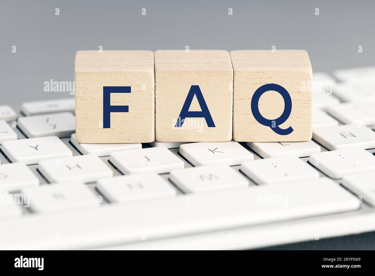 FAQ word on wooden block on computer keyboard. Frequently asked question concept Stock Photo