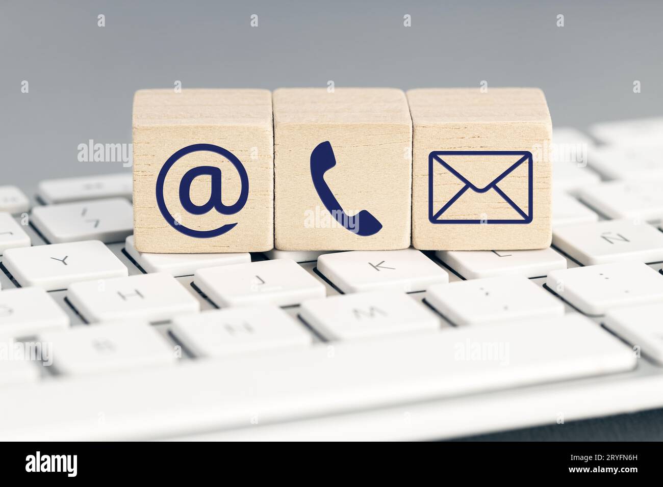 Contact us icons on wooden blocks on computer keyboard Stock Photo