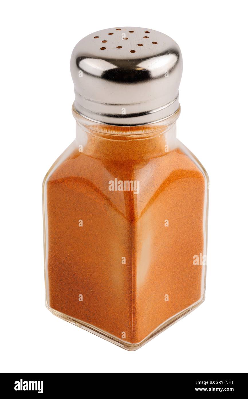 Glass pepper pot with ground red paprika pepper isolated on white