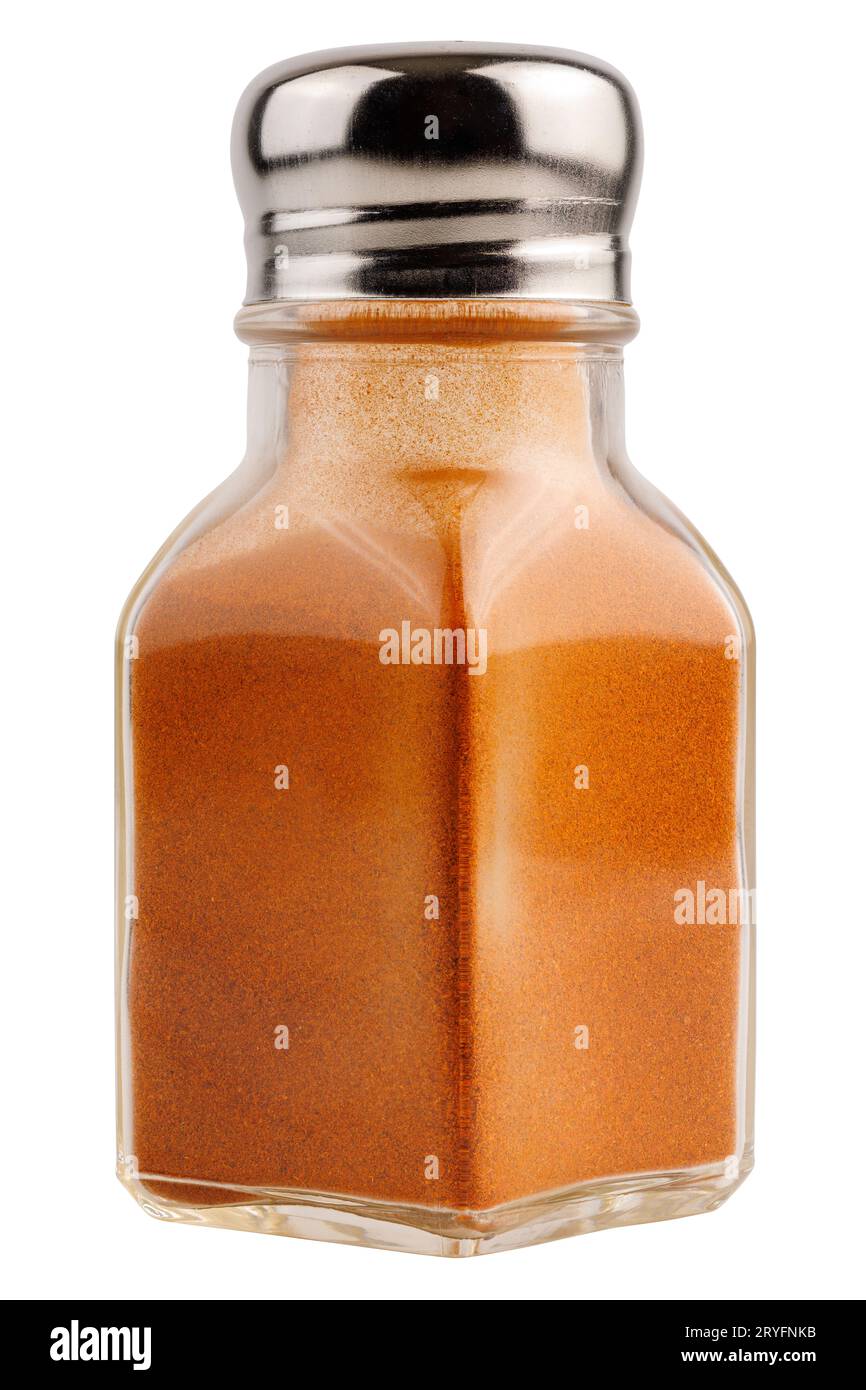 Glass pepper pot with ground red paprika pepper isolated on white