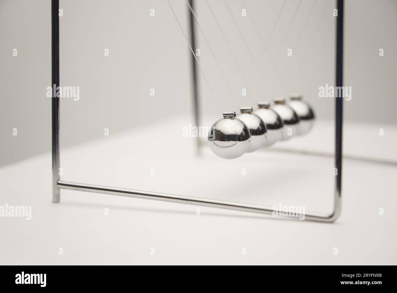 Close-up angle shot of the Newton's cradle. Stock Photo