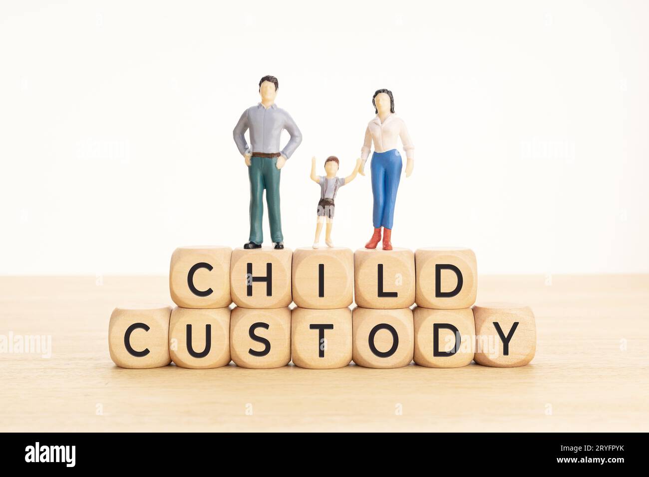 Child custody concept. Wooden blocks with text and woman, man and child figurine Stock Photo