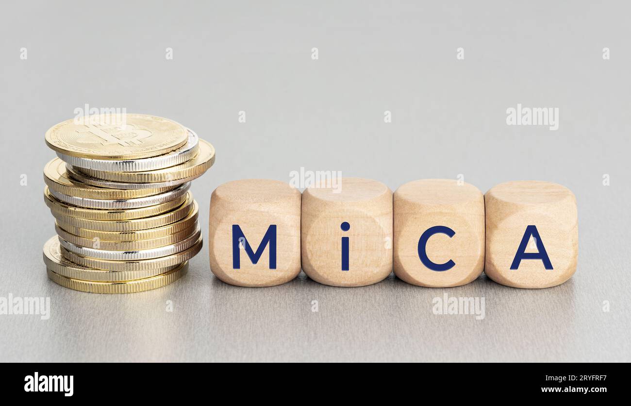 MiCA or Markets in Crypto Assets concept. Stacked cryptocurrency coins and wooden blocks with text. Copy space Stock Photo