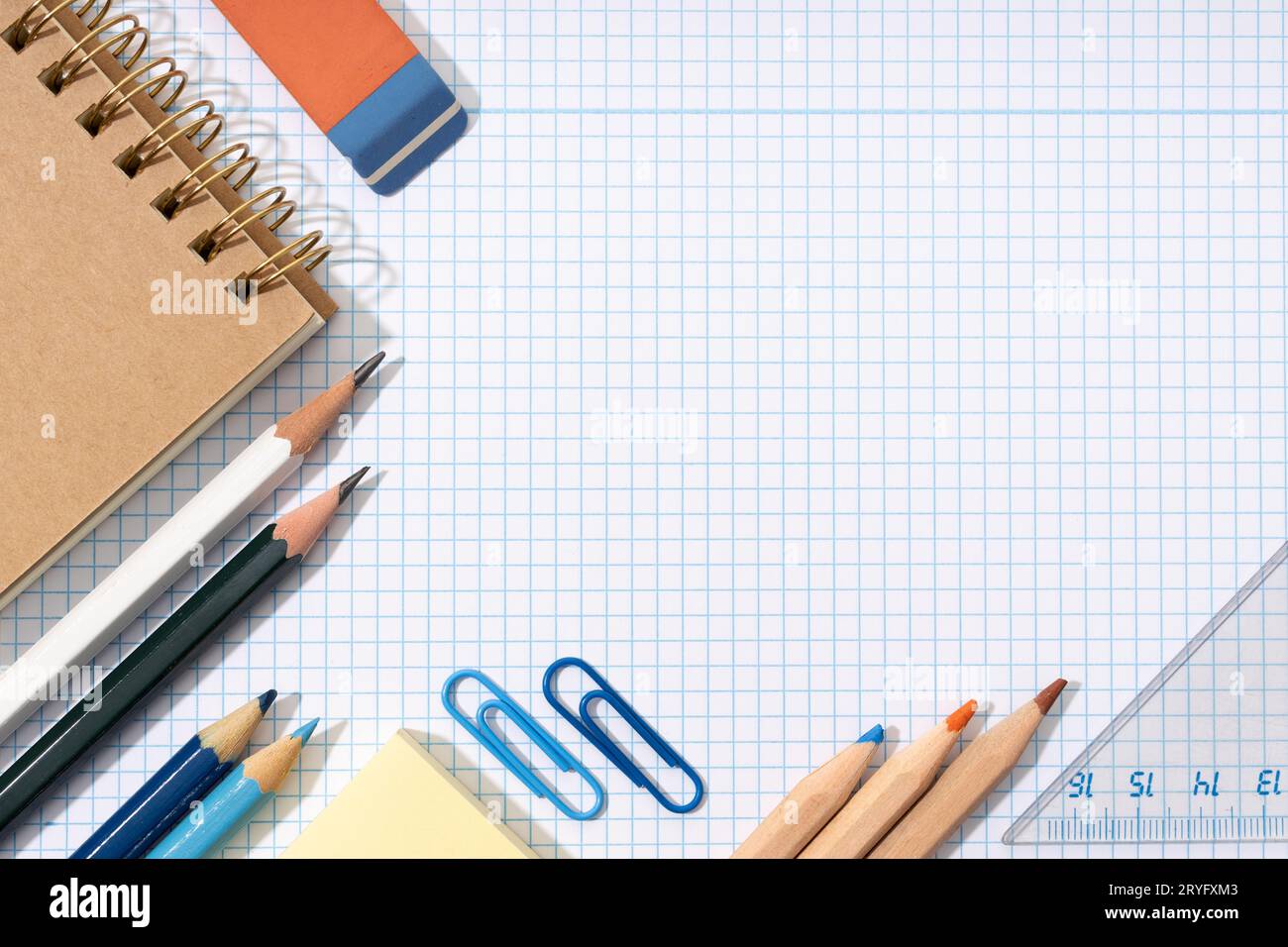Flat lay of School and office supplies on blank graph paper sheet. Back to school background. Copy space Stock Photo