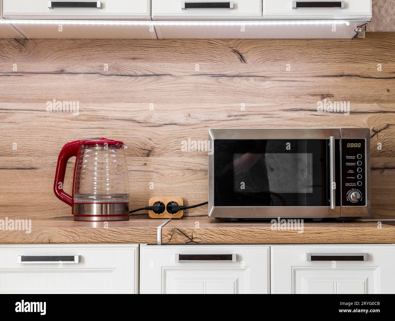 White kitchen set with kitchen utensils on the countertop. Stock Photo