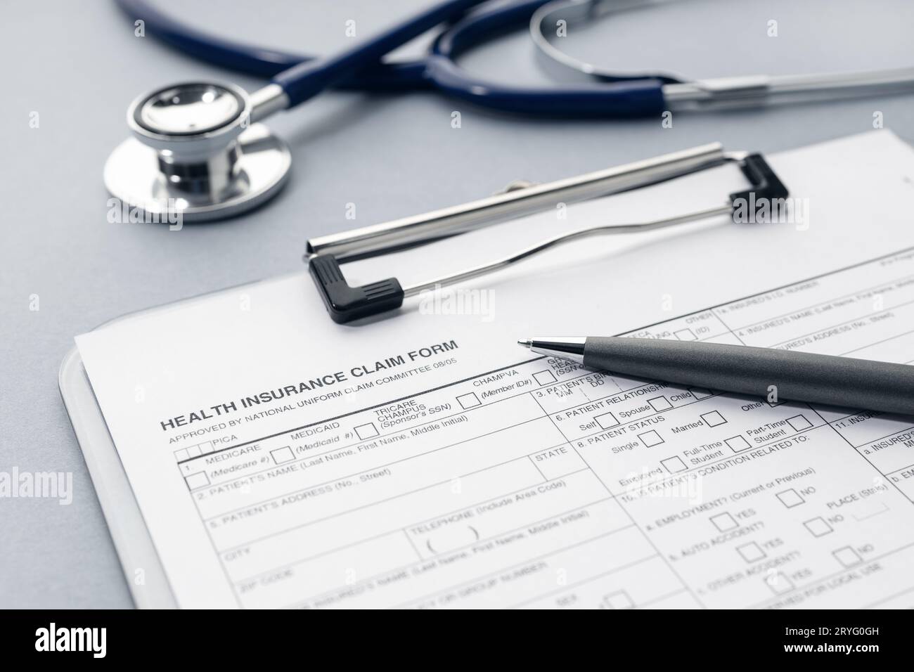 Health Insurance claim form and stethoscope on desk Stock Photo