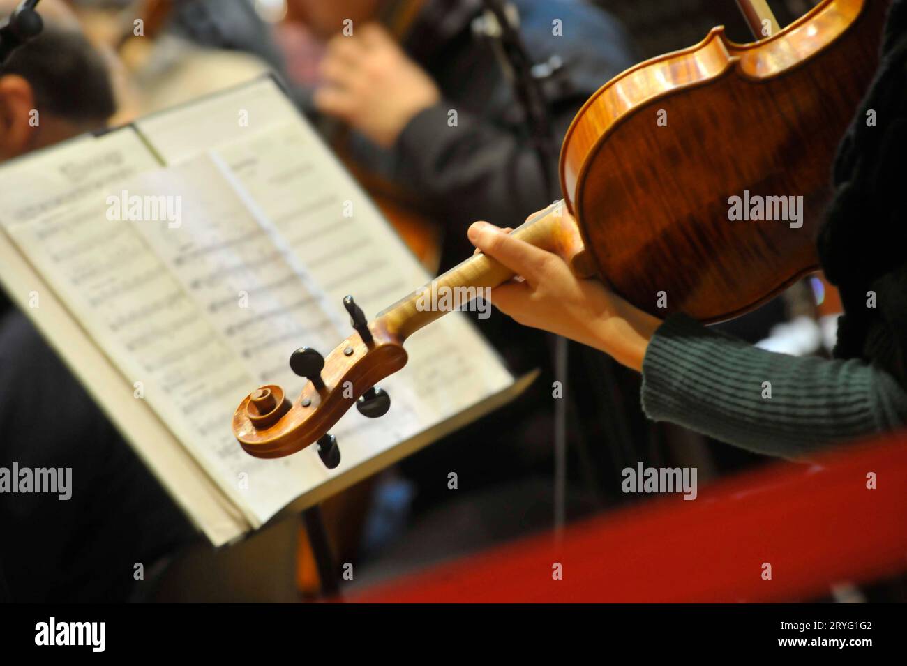 A violinist with violin plays in an orchestra Stock Photo