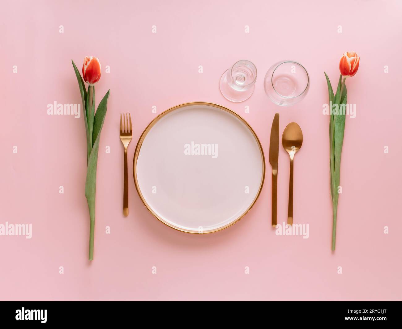 Pink festive table setting on pink, copyspace Stock Photo