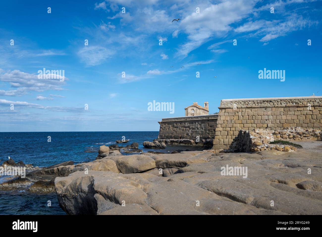 Old walls ant the church of San Pedro and San Pablo in the Tabarca Island, municipality of Alicante, Spain Stock Photo