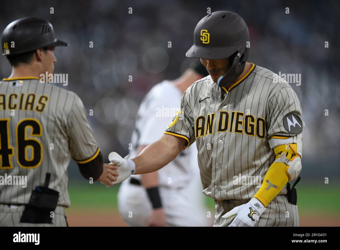 San Diego Padres' HaSeong Kim right, celebrates with first base coach David Macias left, after