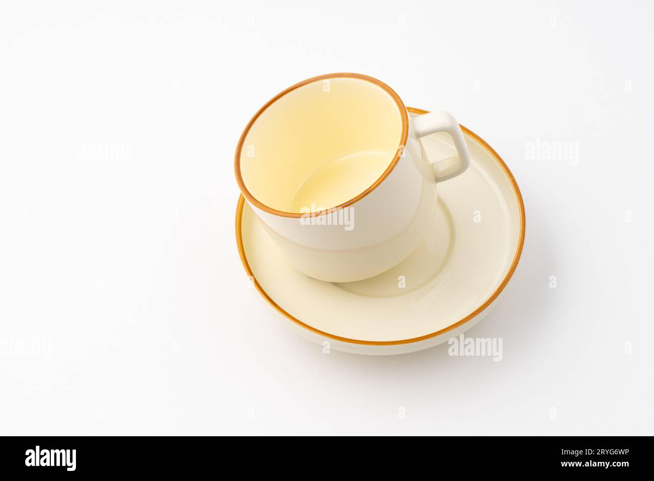 A set of white and brown ceramic plate and cup on a white background Stock Photo