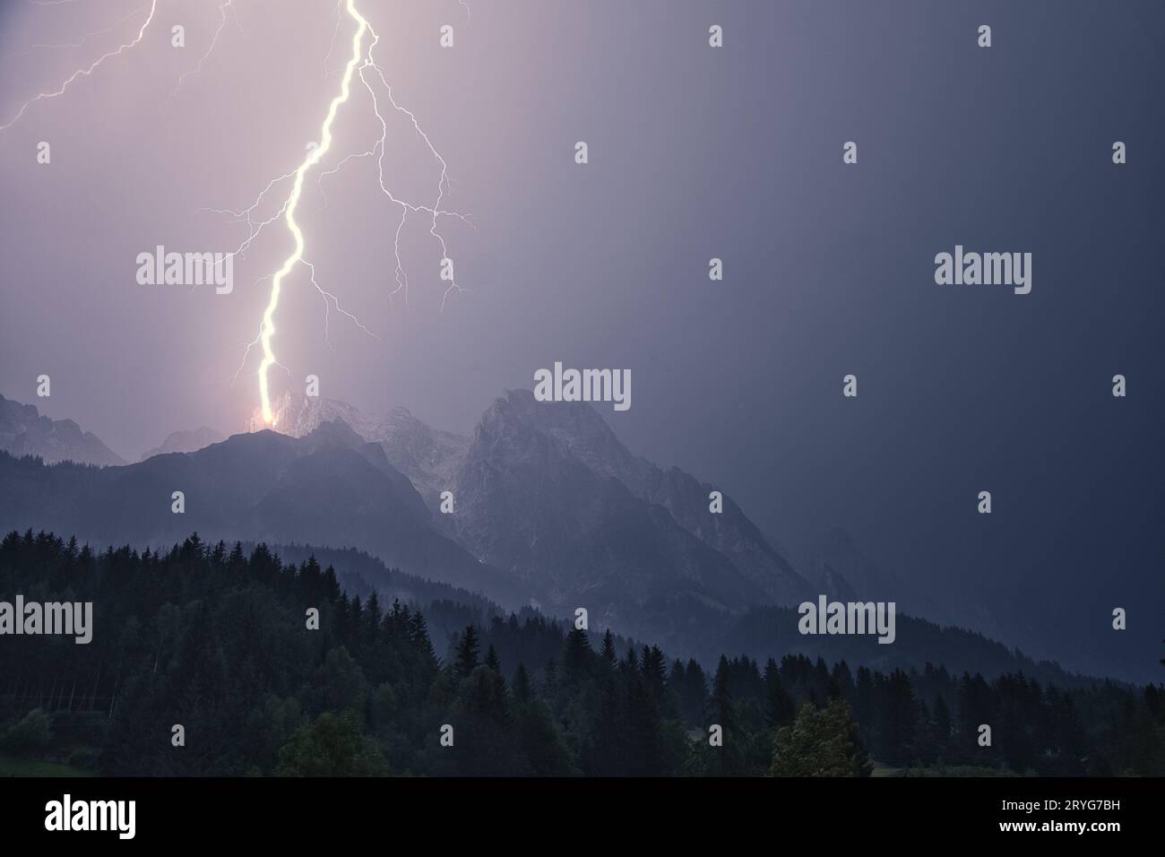 Dramatic lightning strike during a thunderstorm in the Steinberg in Leogang, Salzburg, Austria Stock Photo