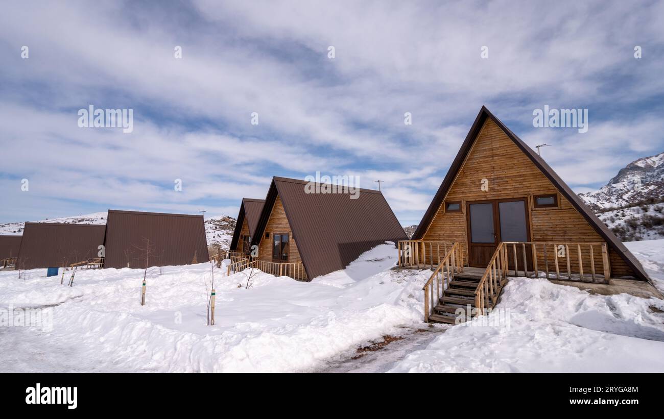 The wooden cottages surrounded by snow. A recreation area in the ...