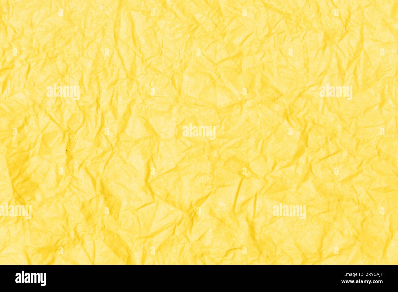 Crumpled paper abstract background texture. Yellow color. Full frame Stock Photo