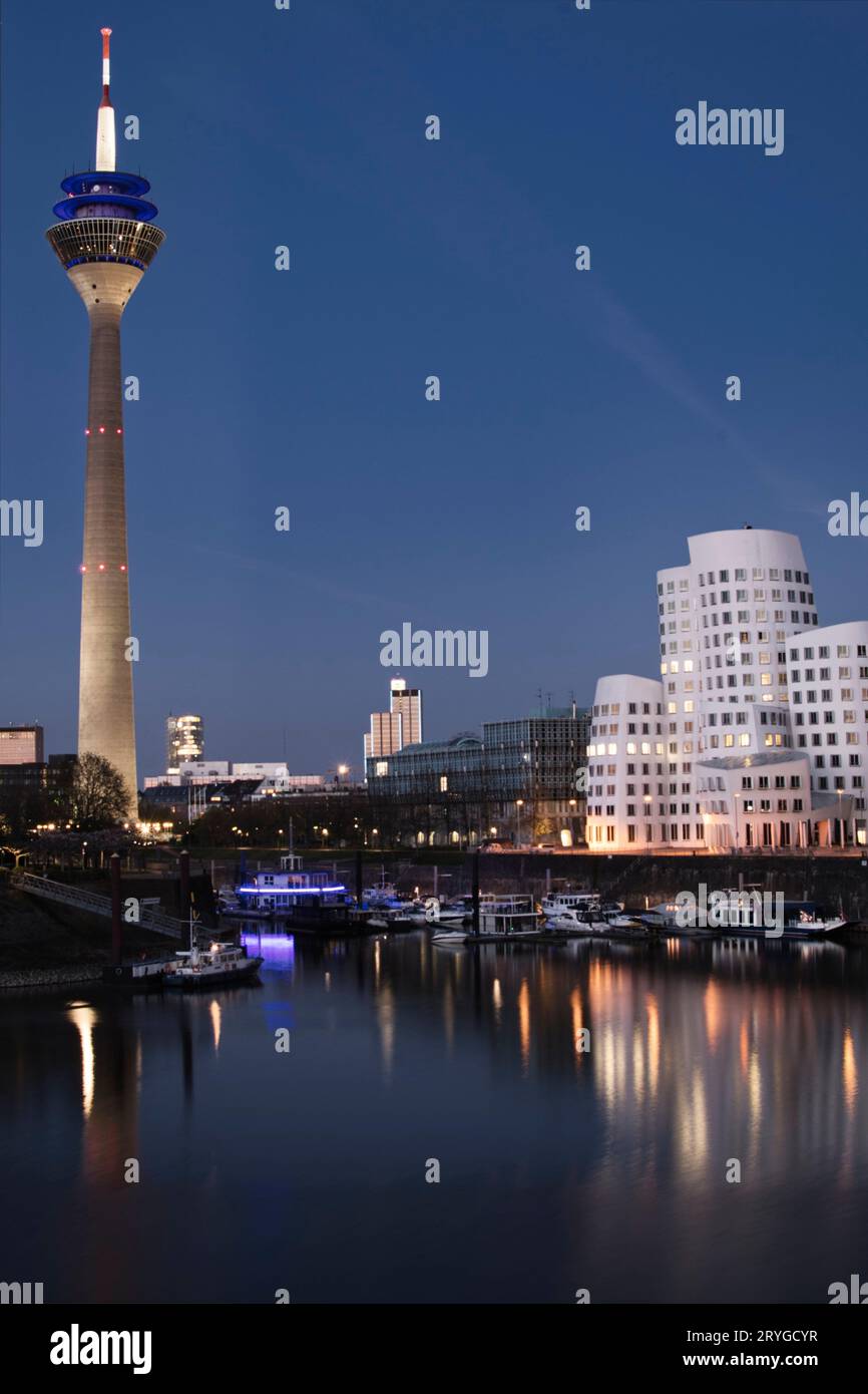 View of Gehry buildings and tv tower at Dusseldorf's media harbor at night Stock Photo