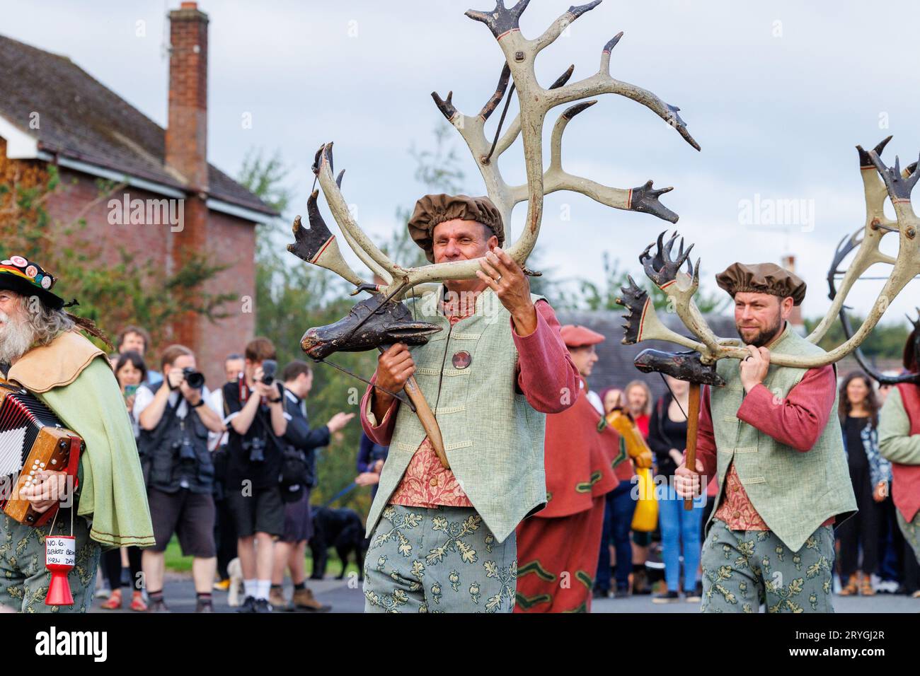 The Abbots Bromley Horn Dancers as they make their way dancing around Abbots Bromley at the start of the day. The dance has been performed since 1226. Antlers are removed from the local church at 7.45am, blessed and the dancers then perform their dances around local villages until 8pm, when once again the antlers are locked away for another year. The annual ritual involves reindeer antlers, a hobby horse, Maid Marian and a fool. Stock Photo