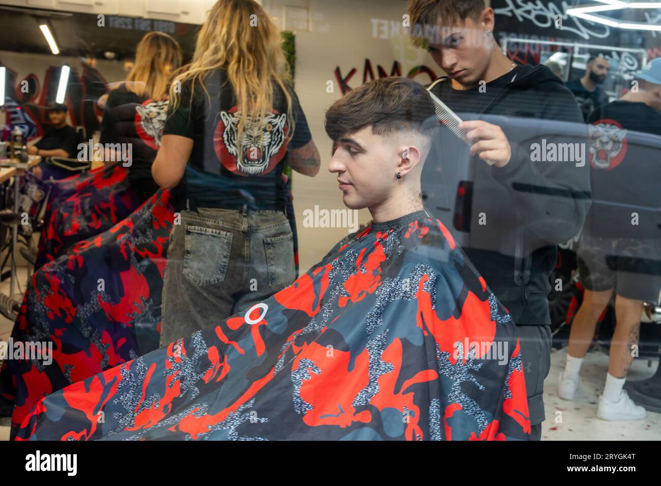 View into a barber shop window from the street, in Newcastle upon Tyne, UK. Stock Photo
