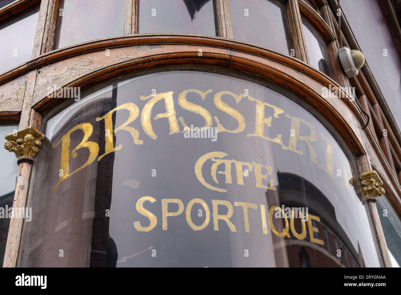 Vintage sign reading, Brasserie Cafe Sportique on a disused building in Middlesbrough, UK. Stock Photo