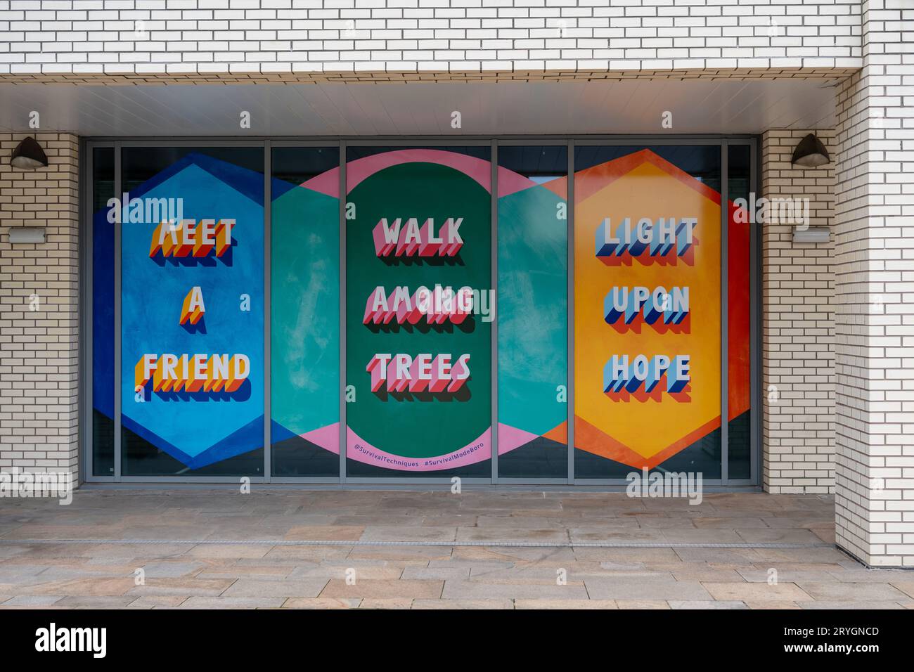 Public art in a window by a walkway in Central Square in the town - Survival Mode: Middlesbrough by Stellar Projects in Middlesbrough, UK Stock Photo