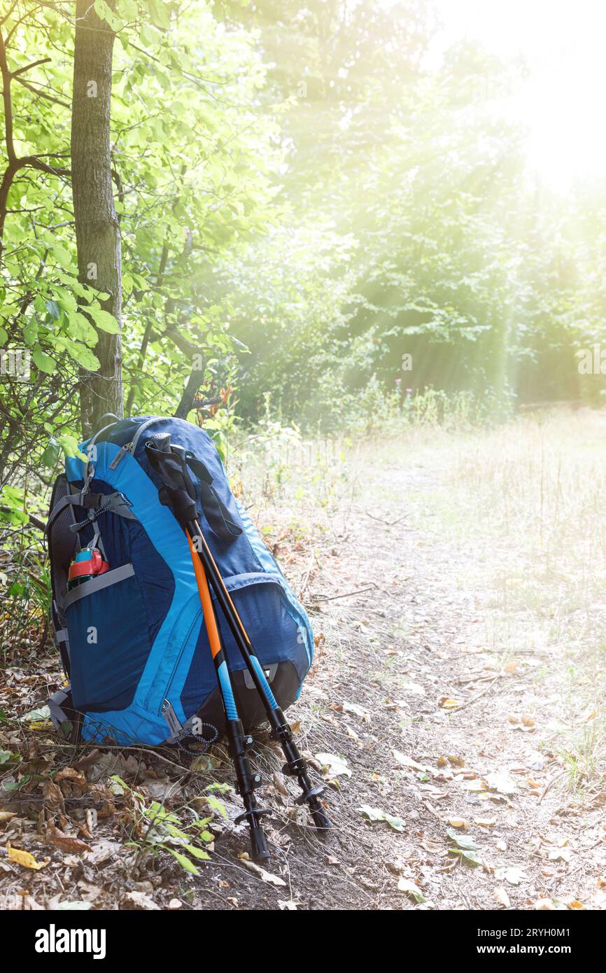 Backpack and trekking poles Stock Photo