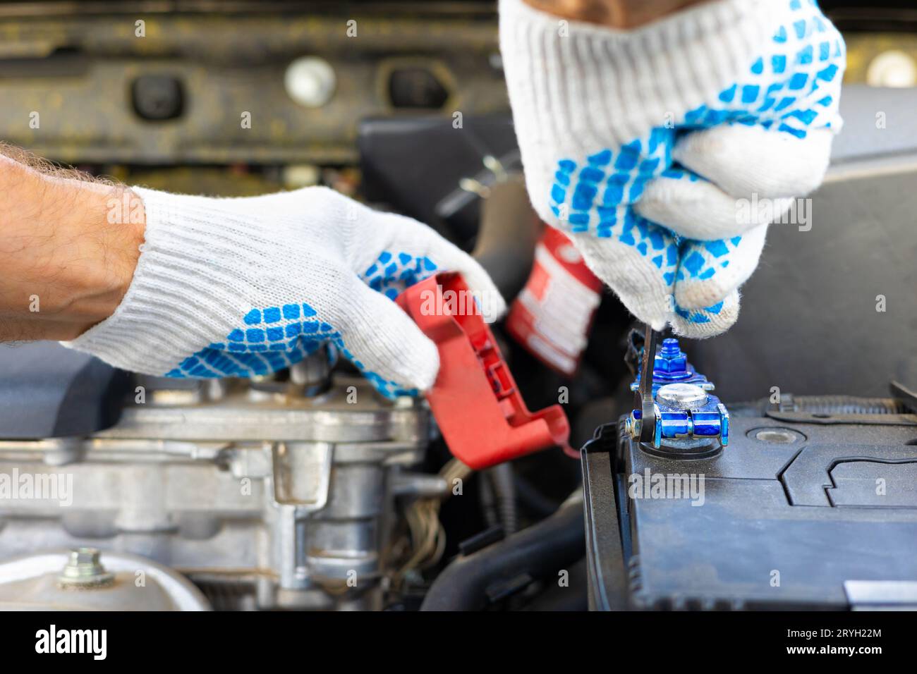 the driver is replacing the car battery. battery terminal installation