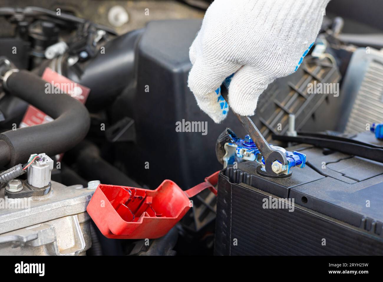 the driver is replacing the car battery. battery terminal installation