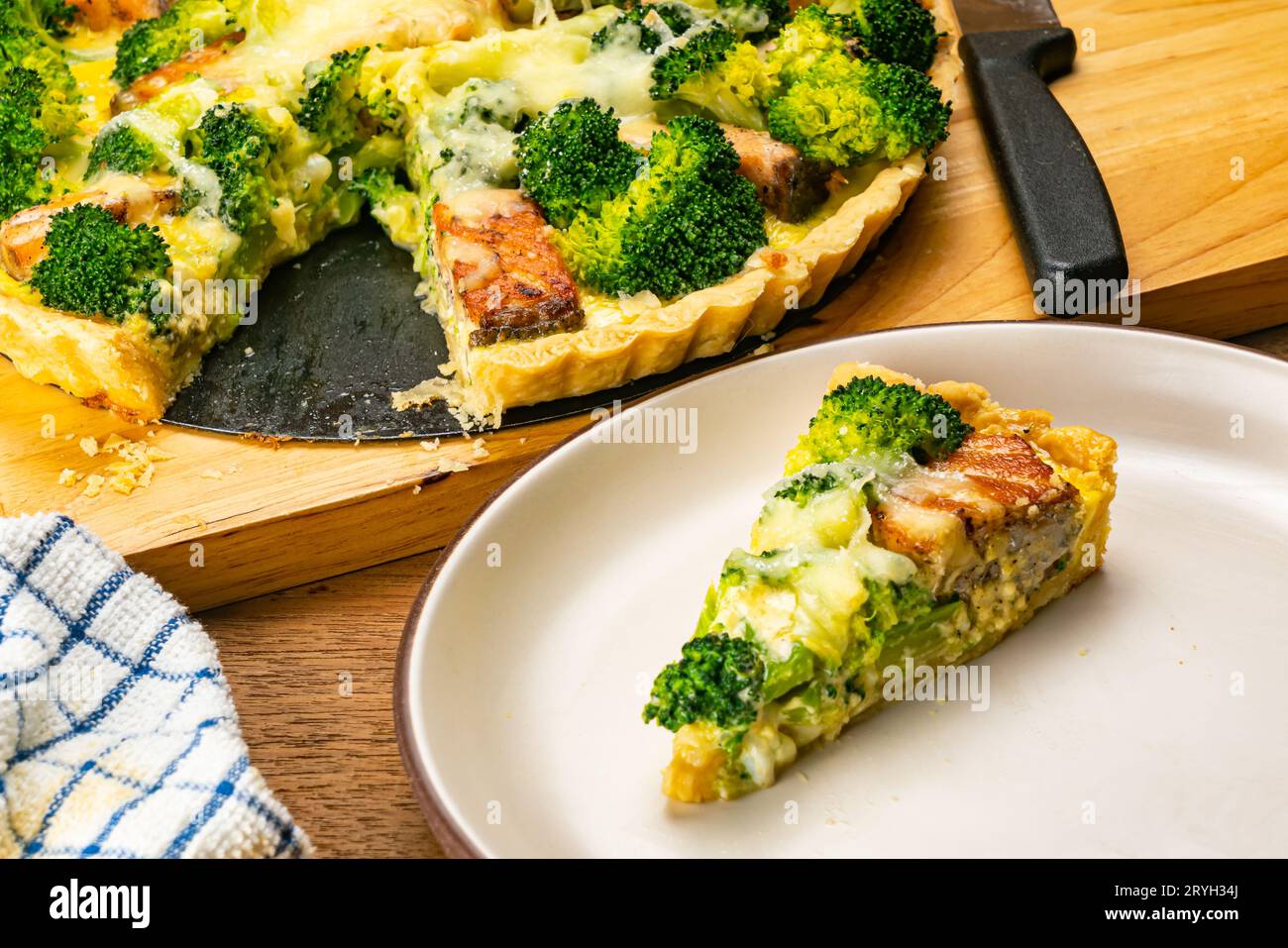 Broccoli and salmon quiche on cutting board. Stock Photo