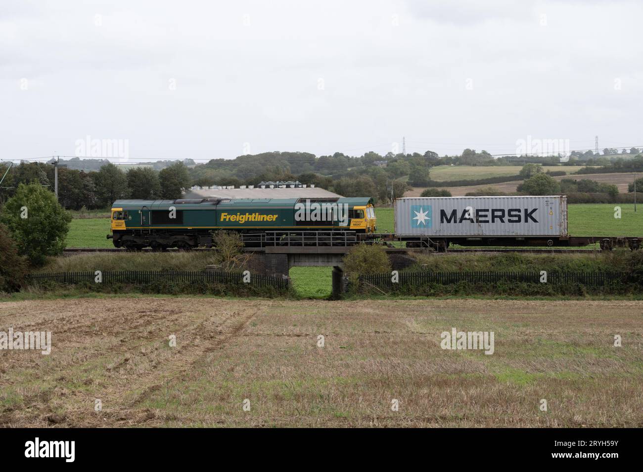 Class 66 diesel locomotive No. 66547 pulling a freightliner train on the West Coast Main Line, Northamptonshire, England, UK Stock Photo