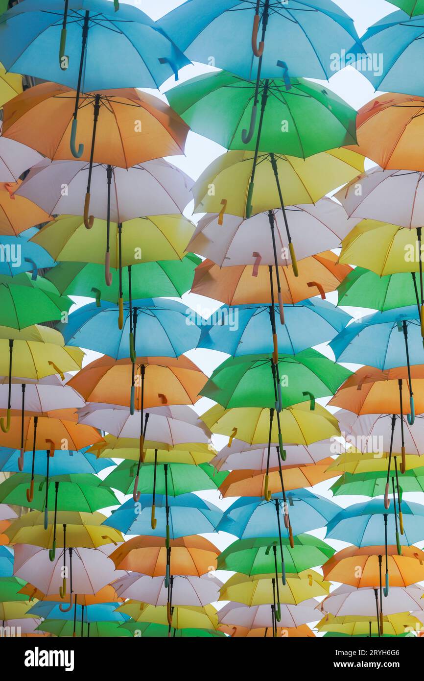 Canopy of brightly coloured umbrellas above a street in the centre of Bordeaux France Stock Photo