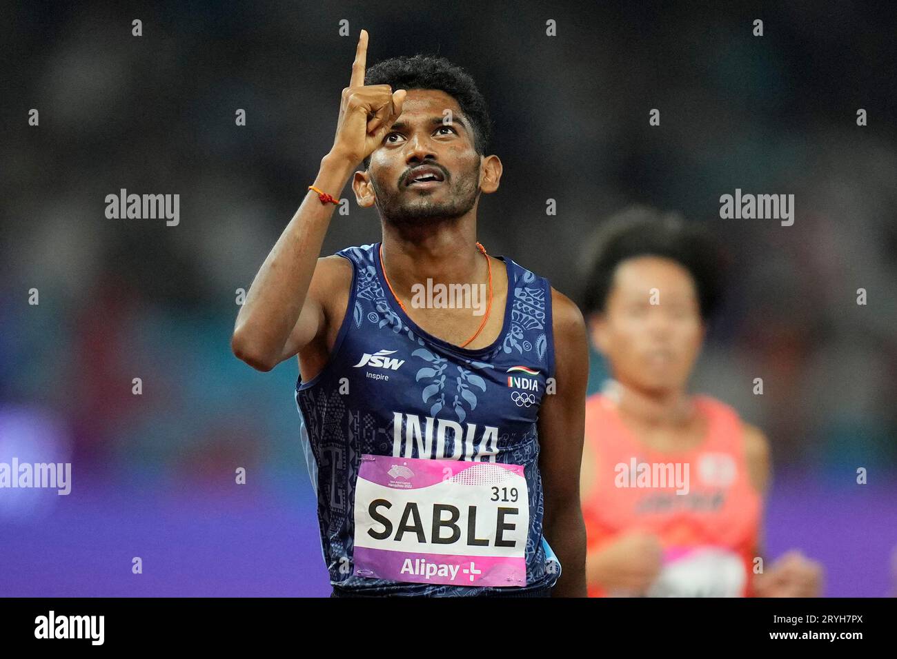 India's Avinash Mukund Sable celebrates after winning the men's 3000