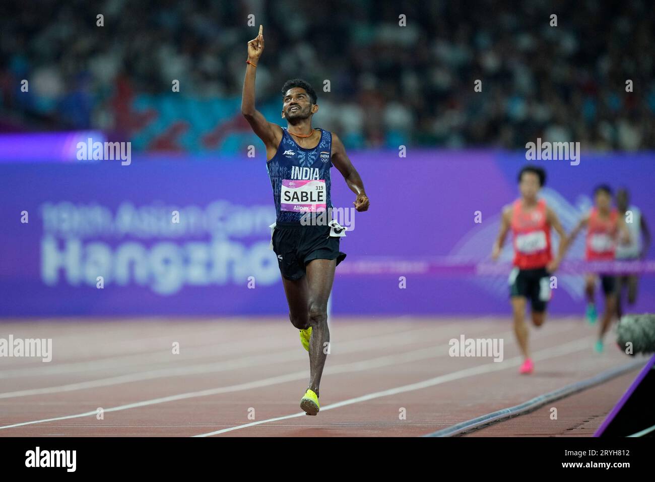 India's Avinash Mukund Sable celebrates as he crosses the finish line