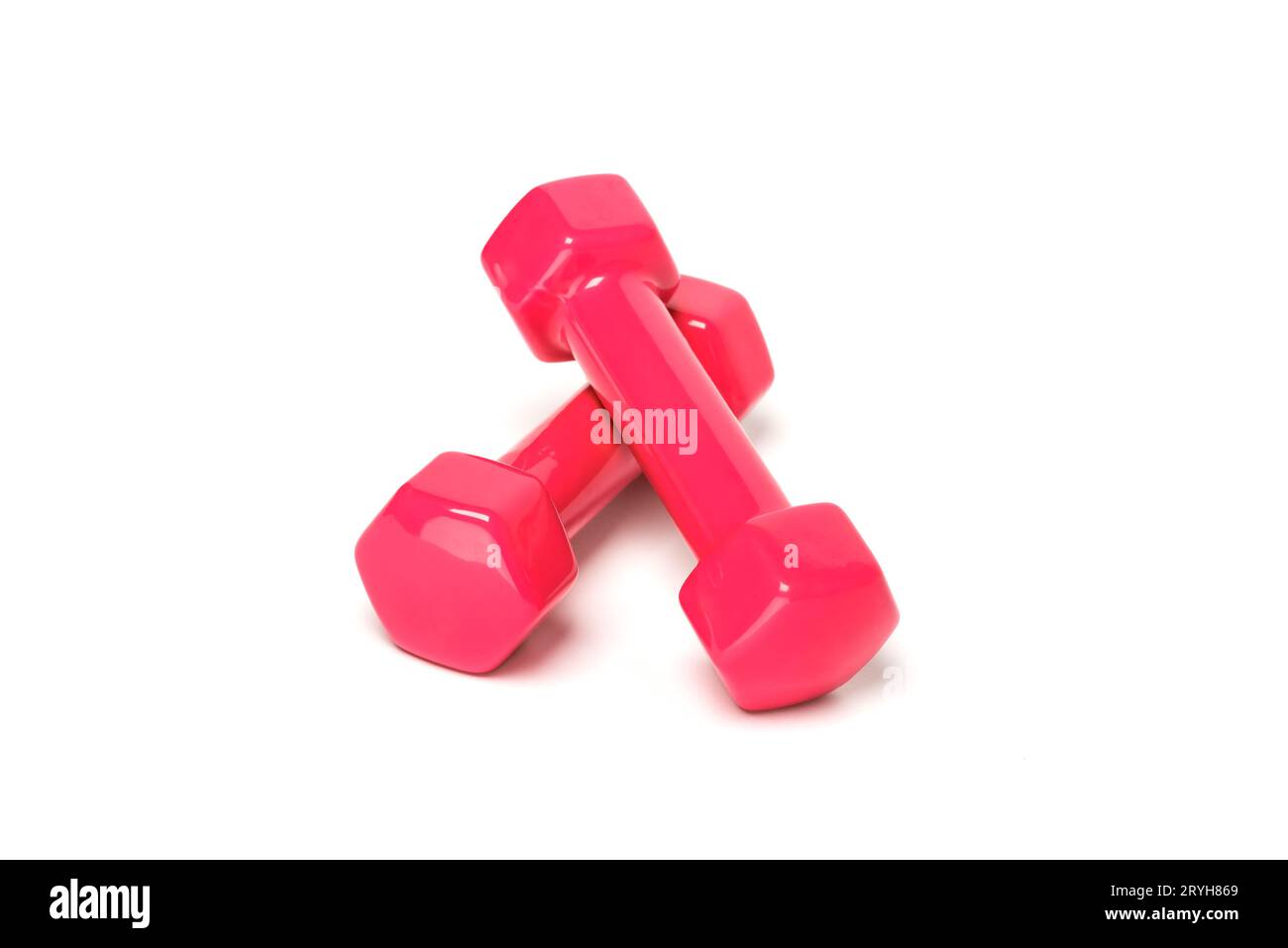 Pink or red dumbbells on a white background. Stock Photo