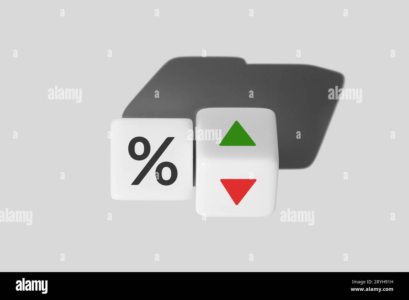 Interest rate and mortgage rates concept. Icon percentage symbol and arrow up and down direction on cube blocks Stock Photo