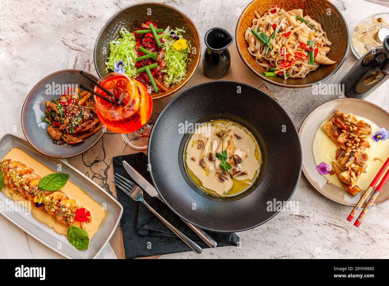 A set of Thai cuisine dishes on a table in a restaurant with a cocktail. View from above. High quality photo Stock Photo