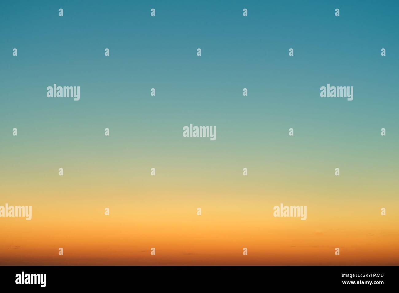 Orange-blue gradient of clear cloudless sky during sunrise Stock Photo