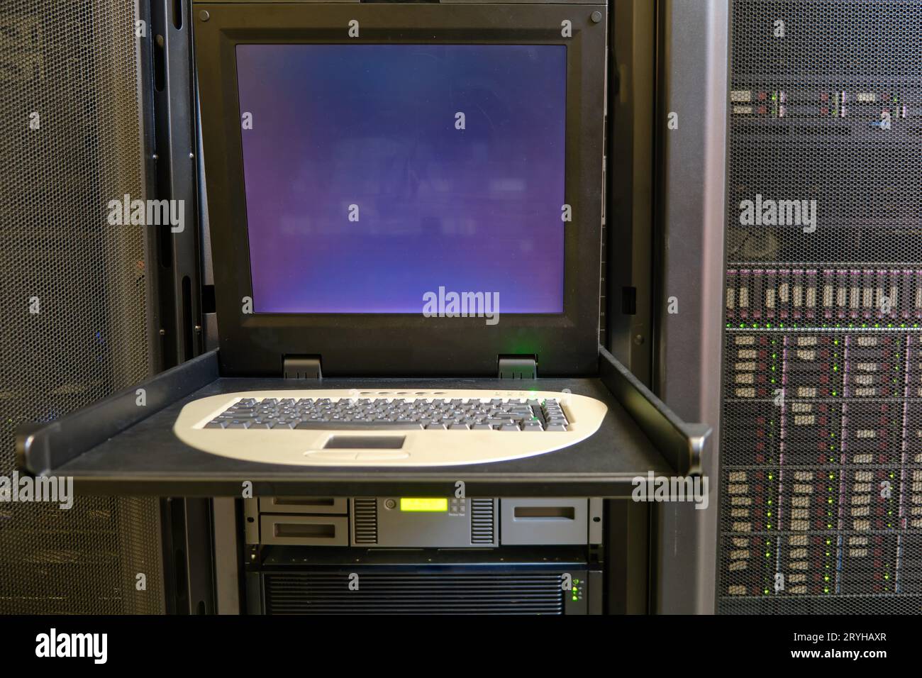 The server room's console panel allows for efficient management of the computer hardware equipment. Stock Photo