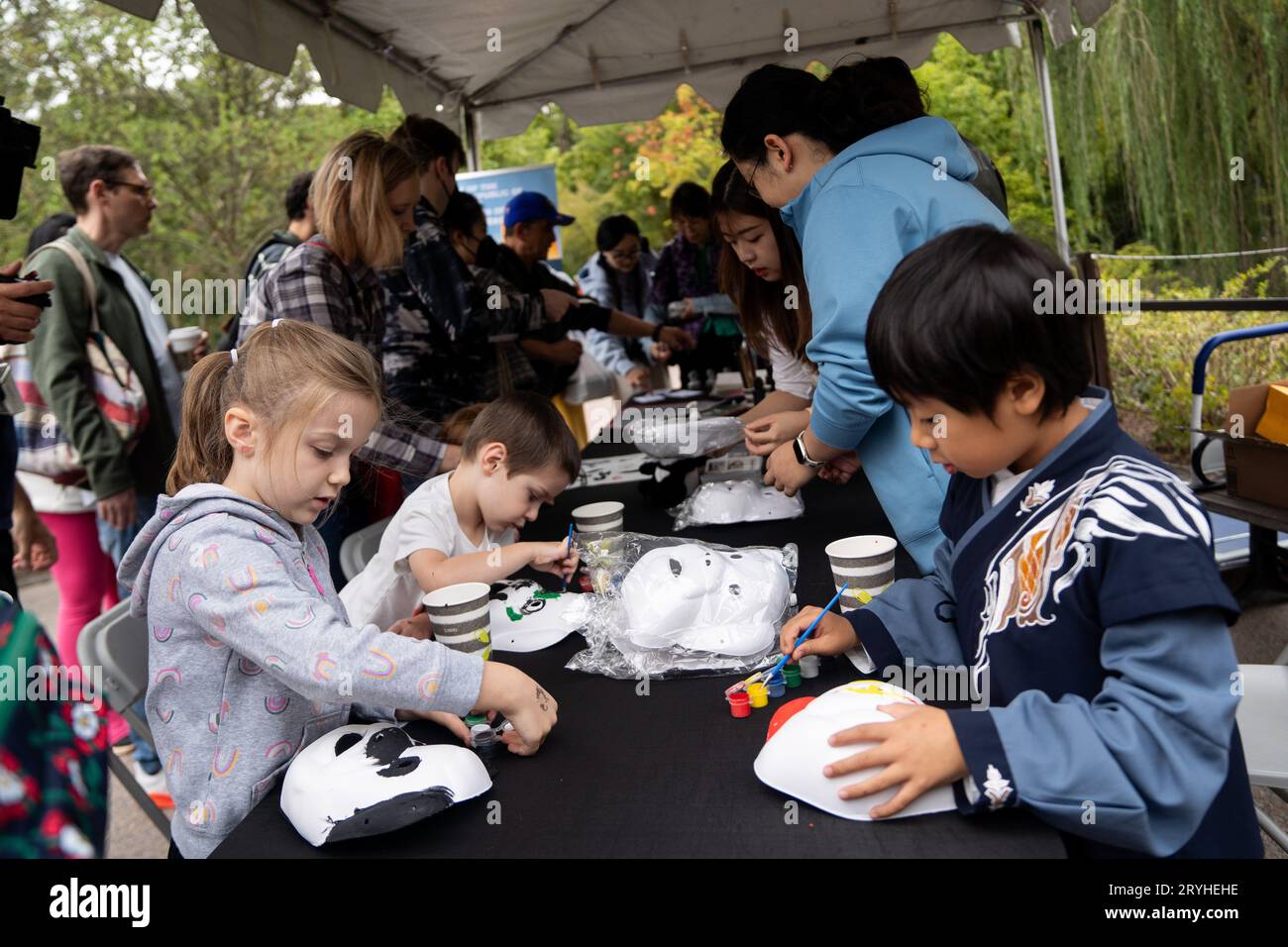 (231001) -- WASHINGTON, Oct. 1, 2023 (Xinhua) -- Children take part in a giant panda mask-making activity at the Smithsonian's National Zoo in Washington, DC, the United States, Sept. 30, 2023. Giant pandas Mei Xiang, Tian Tian and Xiao Qi Ji, who are currently staying at the Smithsonian's National Zoo, will be returned home by the end of the year in accordance with a previous agreement with the China Wildlife Conservation Association (CWCA). To celebrate the joy the pandas have brought to the American people and say goodbye to them, the zoo held a 'giant farewell' event during the week en Stock Photo