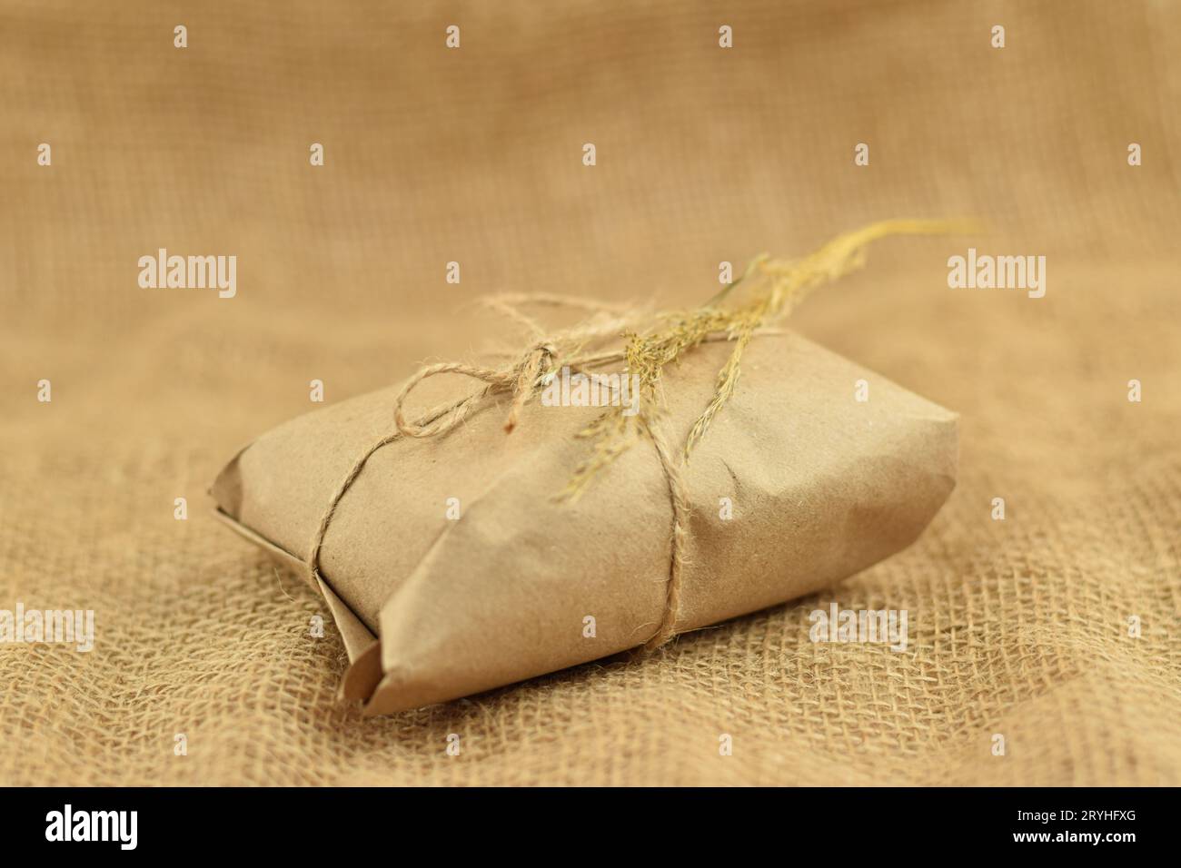 Simple eco friendly gift boxes package wrap with brown paper. Burlap